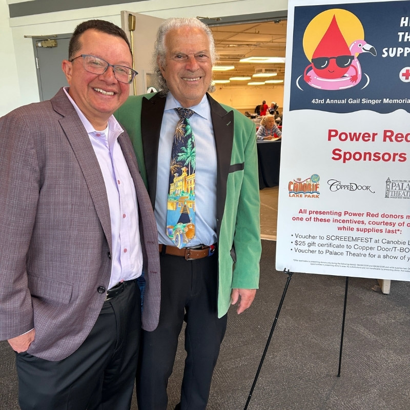 Two men standing at the entrance of a blood drive.