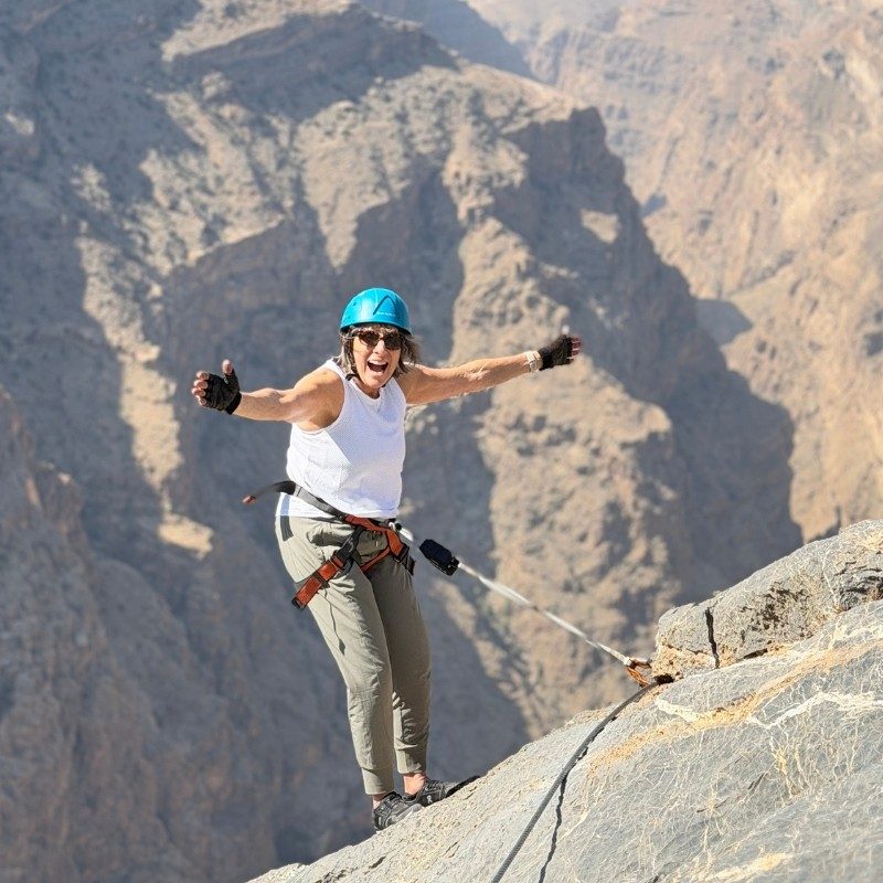 Shari Donnermeyer standing on the top of a mountain.