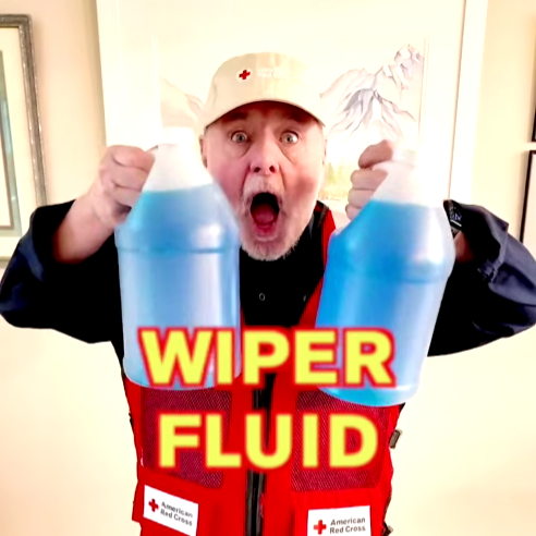 man holding two jugs of wiper fluid