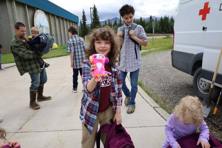 Young child holds stuffed animal