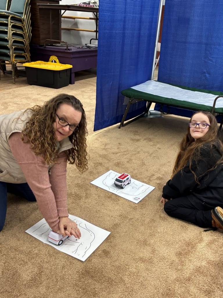 Woman and young girl practice compressions