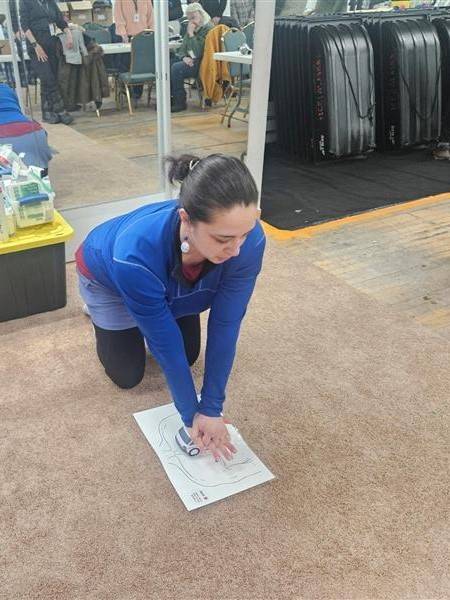 Woman practices chest compressions