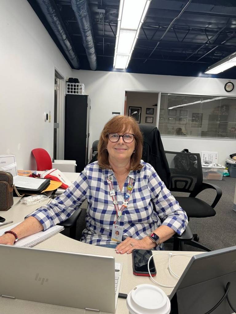 Woman sits at desk