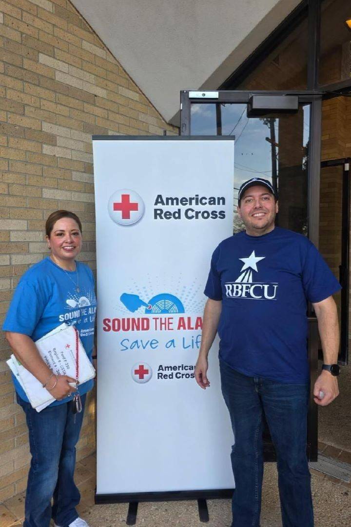 Image of man and woman with Sound the Alarm sign