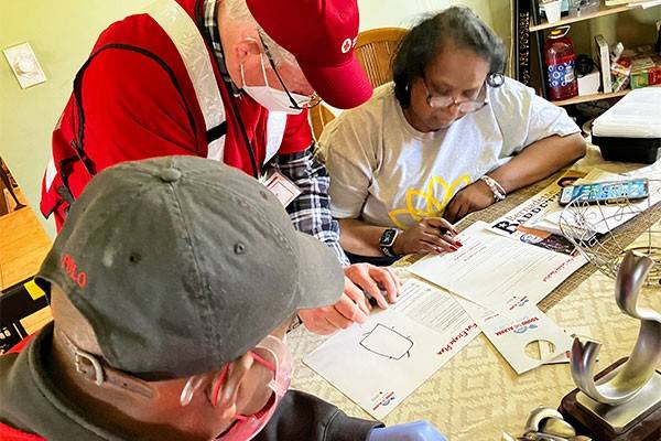 Red Cross volunteers going over fire escape plan with resident