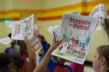 children holding prepare with pedro pamplets 