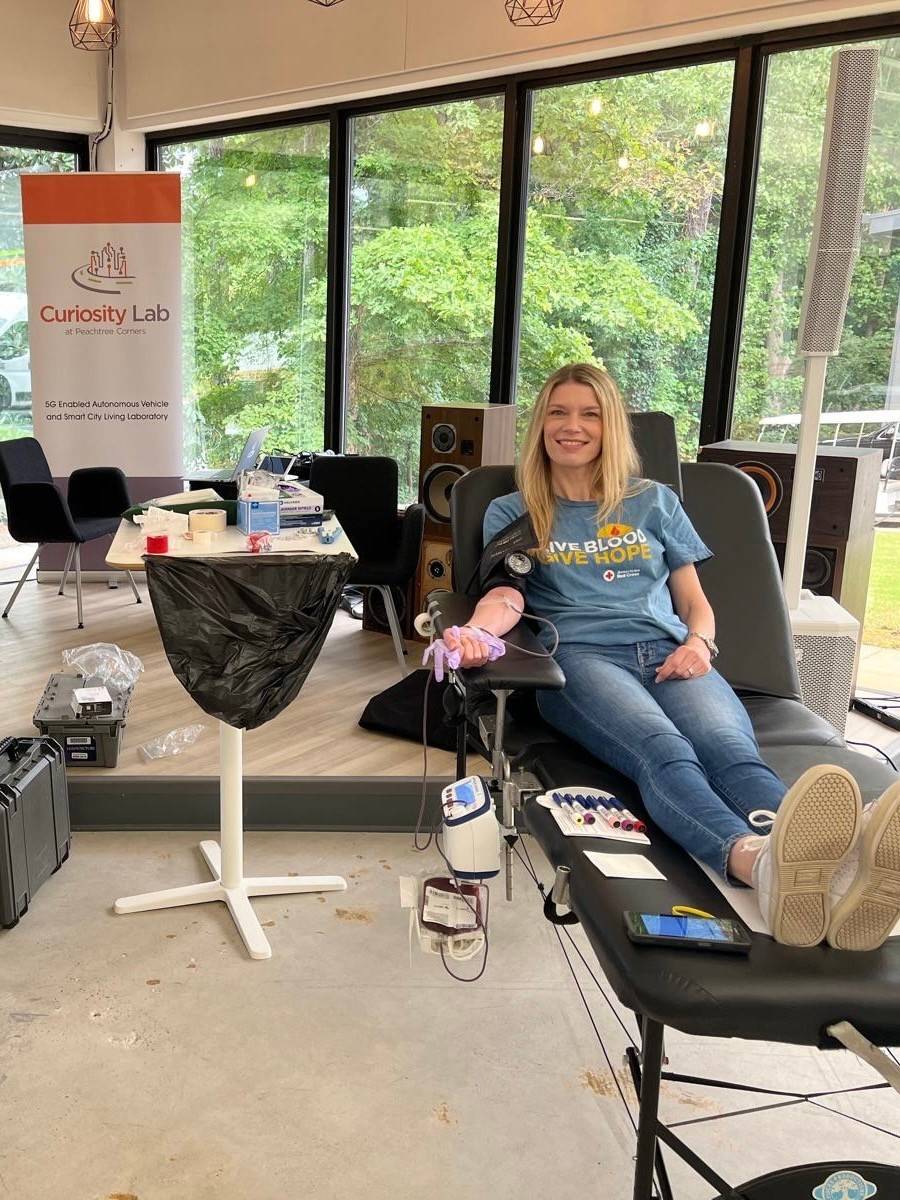 Woman smiles while donating blood with the Red Cross