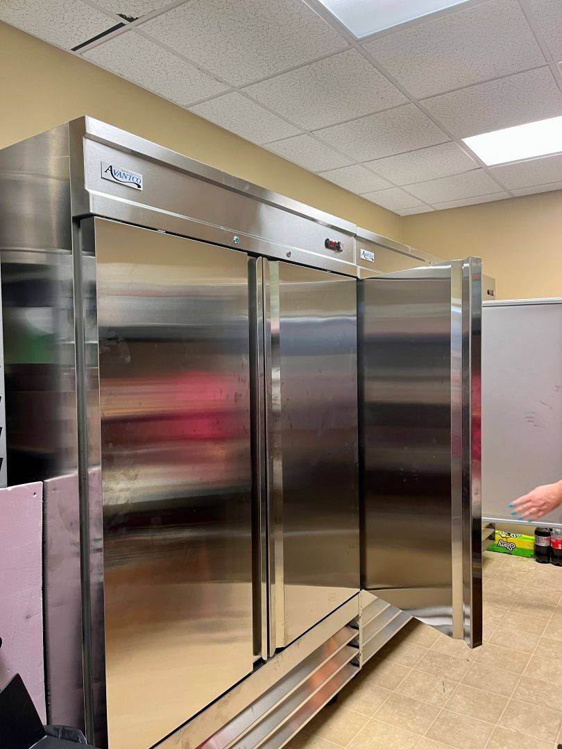 Refrigerator sits in kitchen space