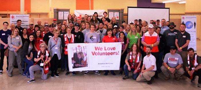 Volunteers standing in front of Red Cross van
