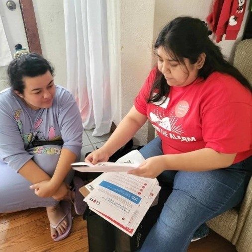two women talking over paperwork