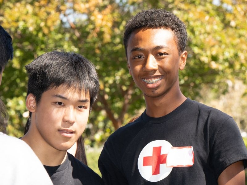 two youth volunteers smiling