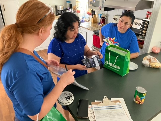 two red cross volunteers talking with client