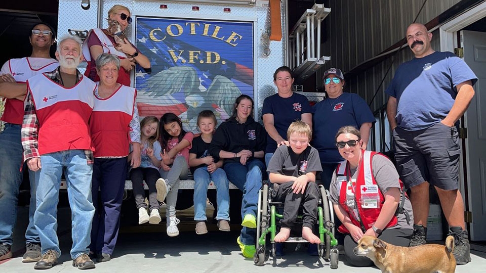 Group of volunteers in front of a fire engine.