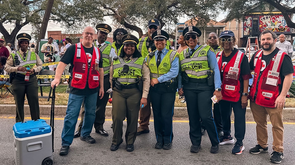 group photo of red crossers with local law enforcement at mardi gras.