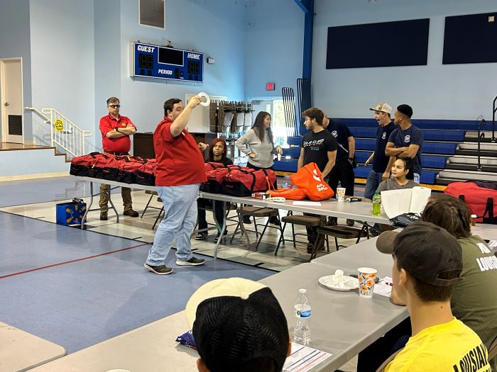 red cross volunteer giving instruction to a group