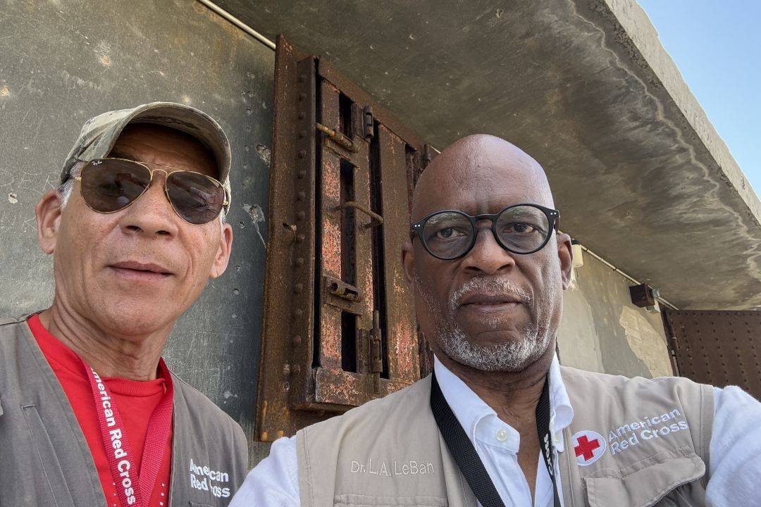 Selfie of two male Red Cross volunteers on deployment together