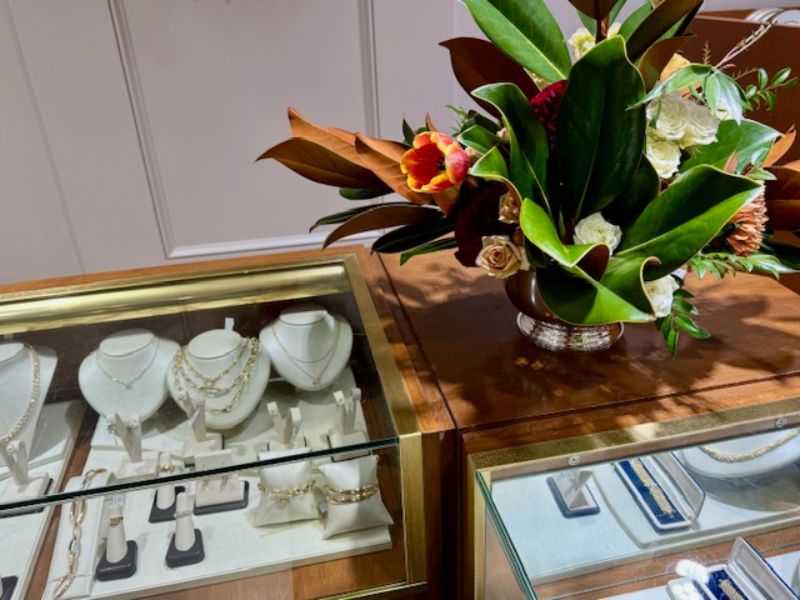 A jewlery showcase with necklaces and rings.