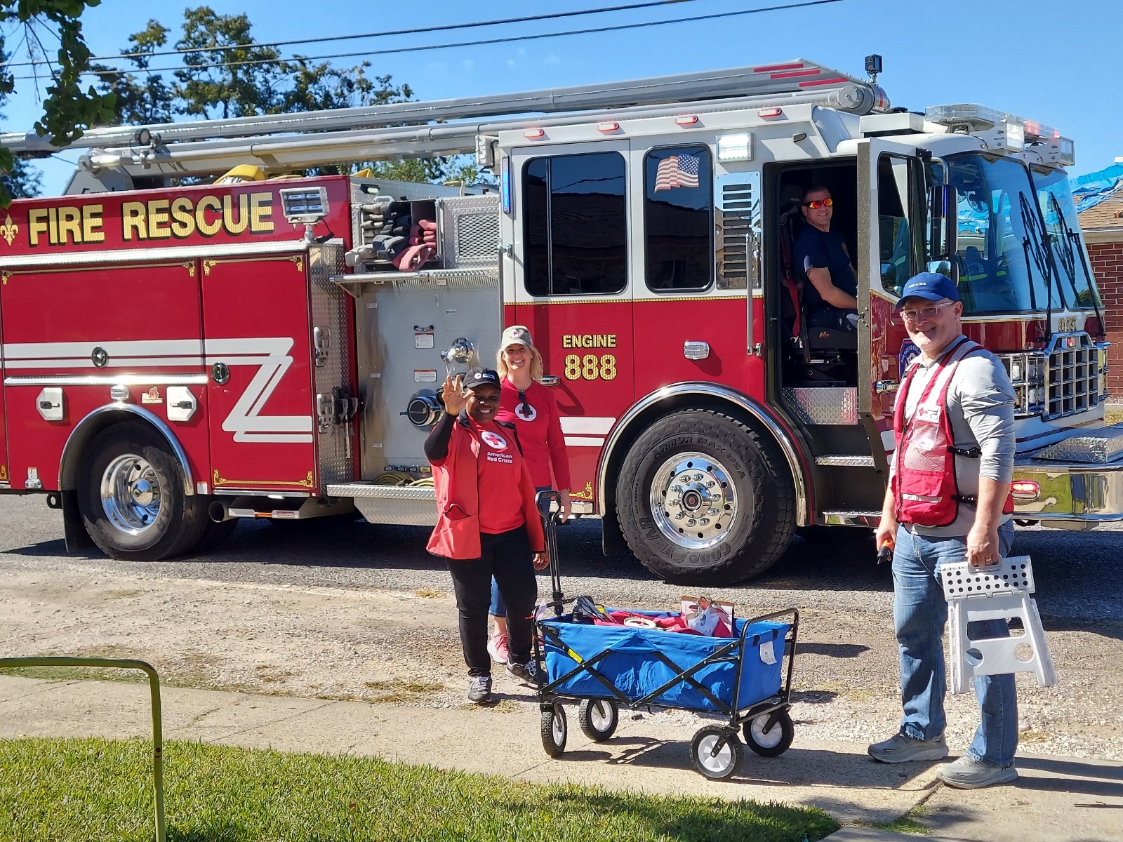 red cross volunteers in front of fire truck