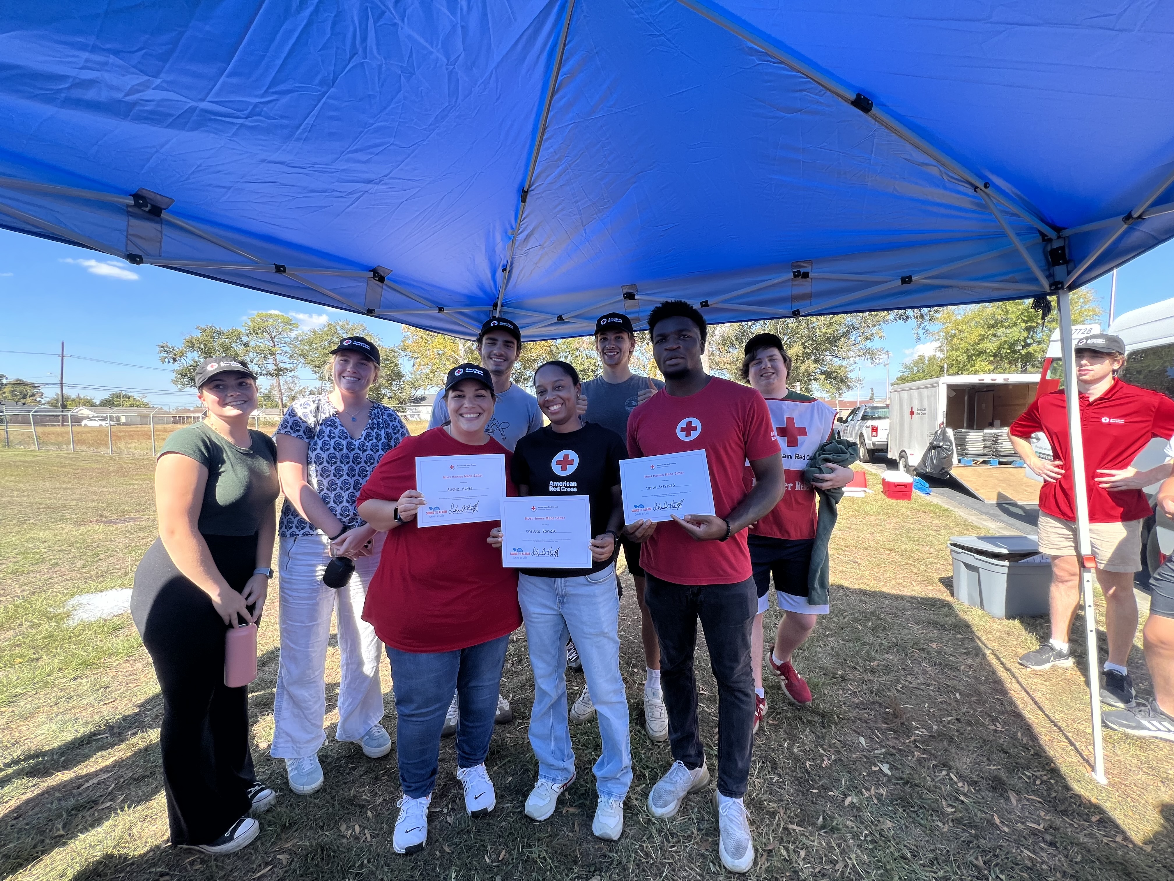 volunteers holding certificates