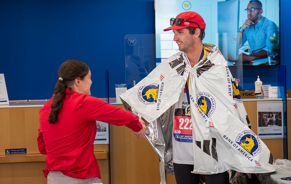 Marathon runner shaking hands with another person