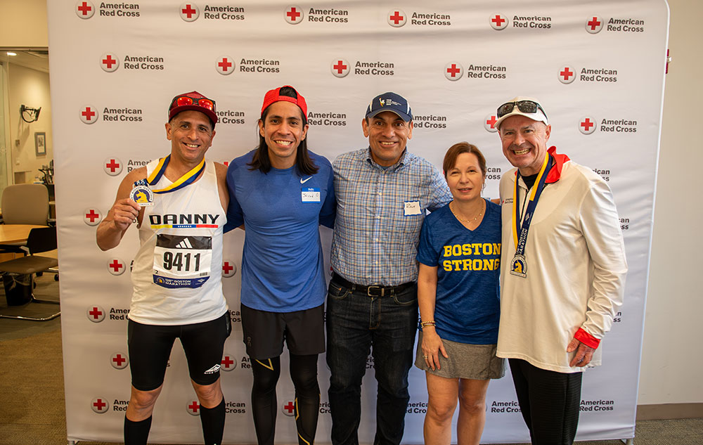 Group shot of marathon runners showing medals