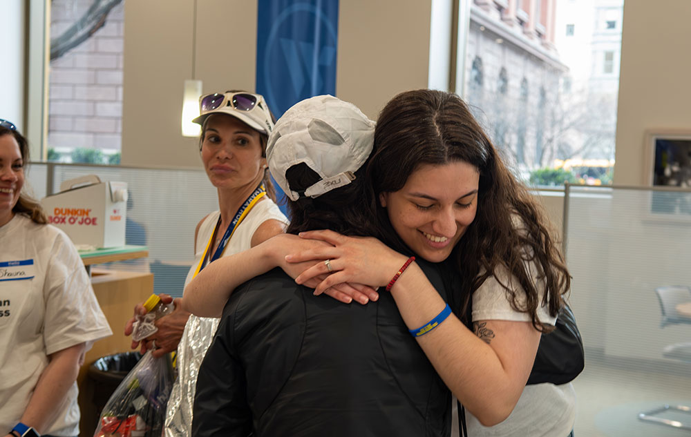 Two people hugging each other