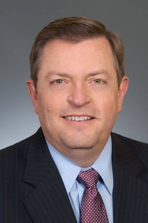 man in blue blazer in red and white tie