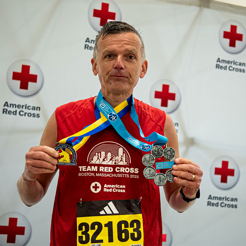 Paul G. showing medals won in marathon