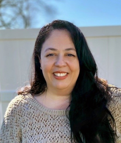 woman smiling in cram sweater