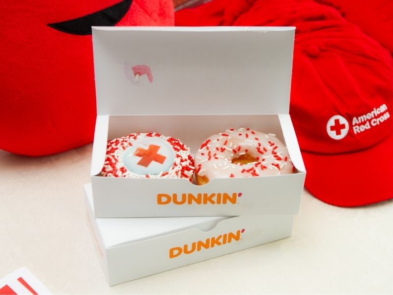 box of dunkin donuts and red cross hats