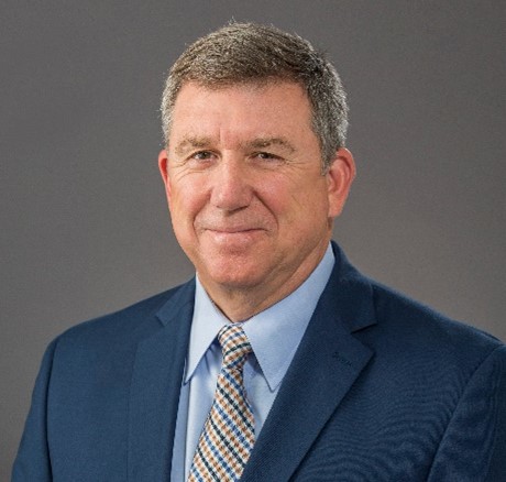 man in blue blazer and light blue shirt and striped tie