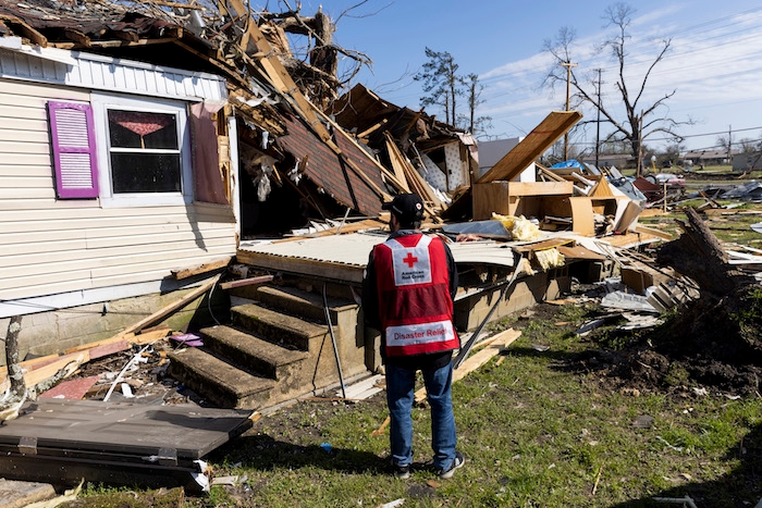 Red Cross male employee standing in front of a Chevy Silverado pickup truck