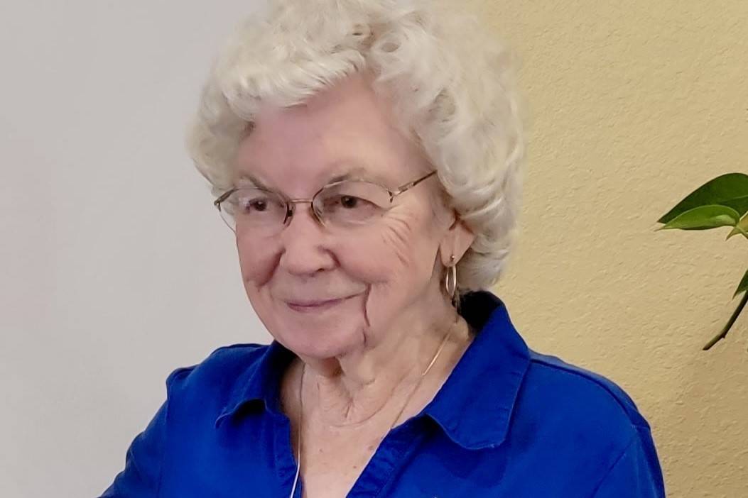 headshot of woman in blue shirt