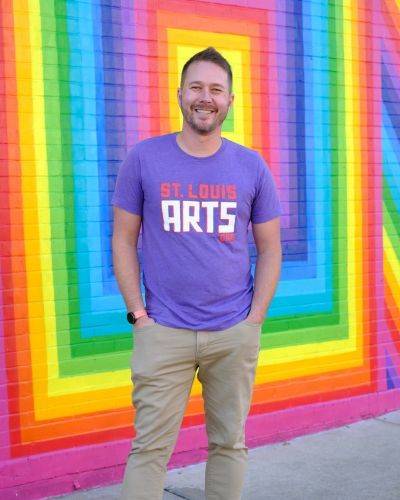 jay scherder in front of colorful mural