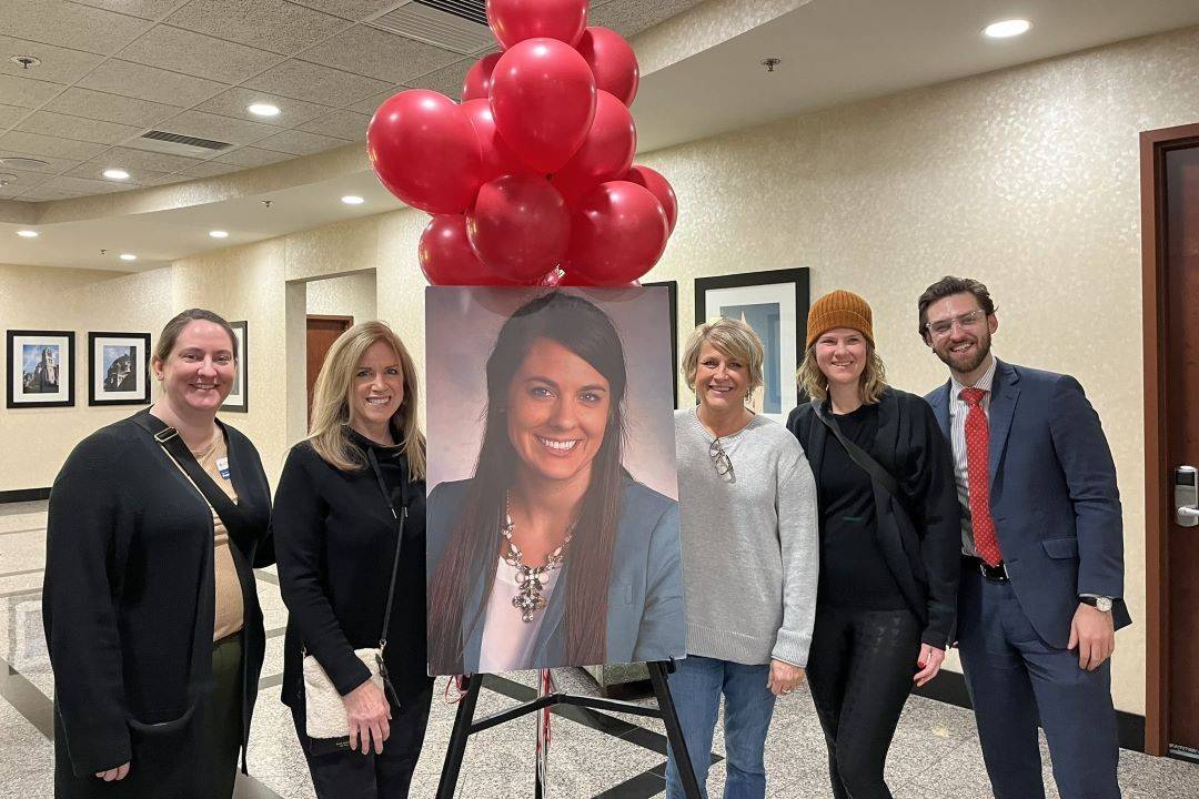Group photo around image of woman
