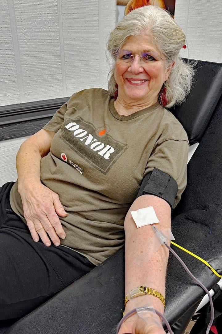 Woman smiles while donating blood