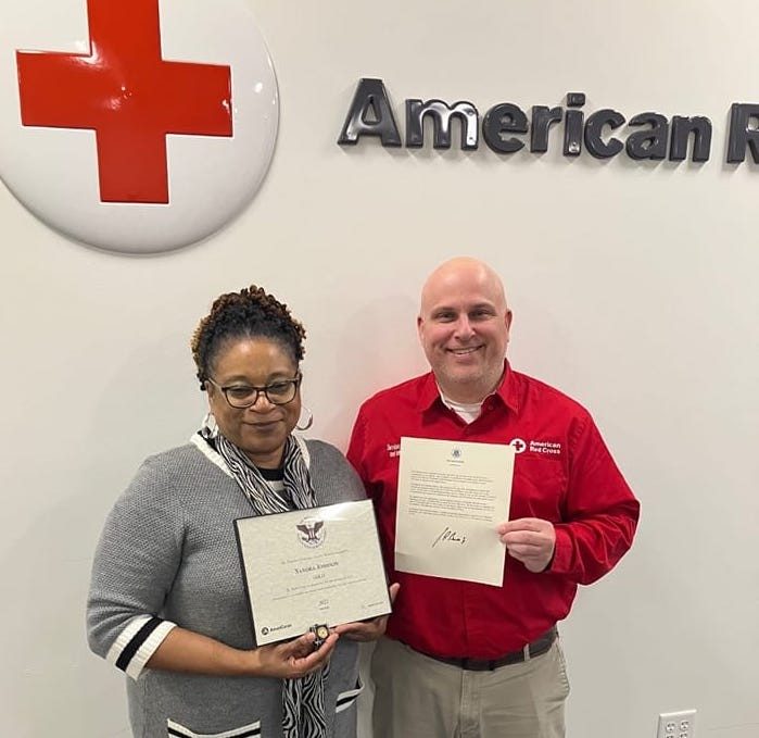 Sandra Johnson, holding Presidential Volunteer Service Gold Award