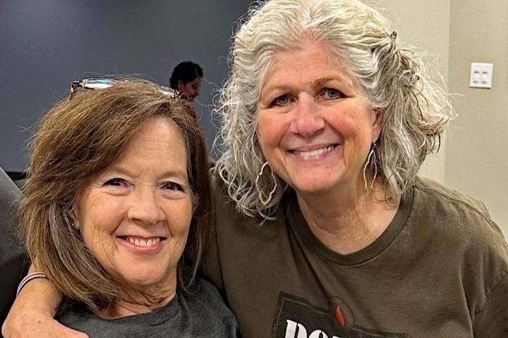 two women smile at camera