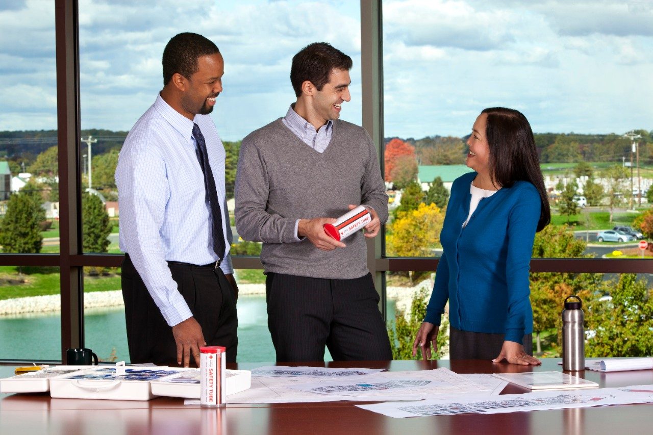 group of three peple talking in office