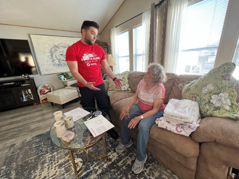 red cross volunteer helping client at home