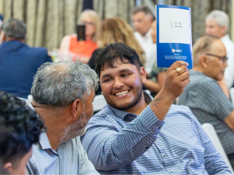 attendee holding pamphlet