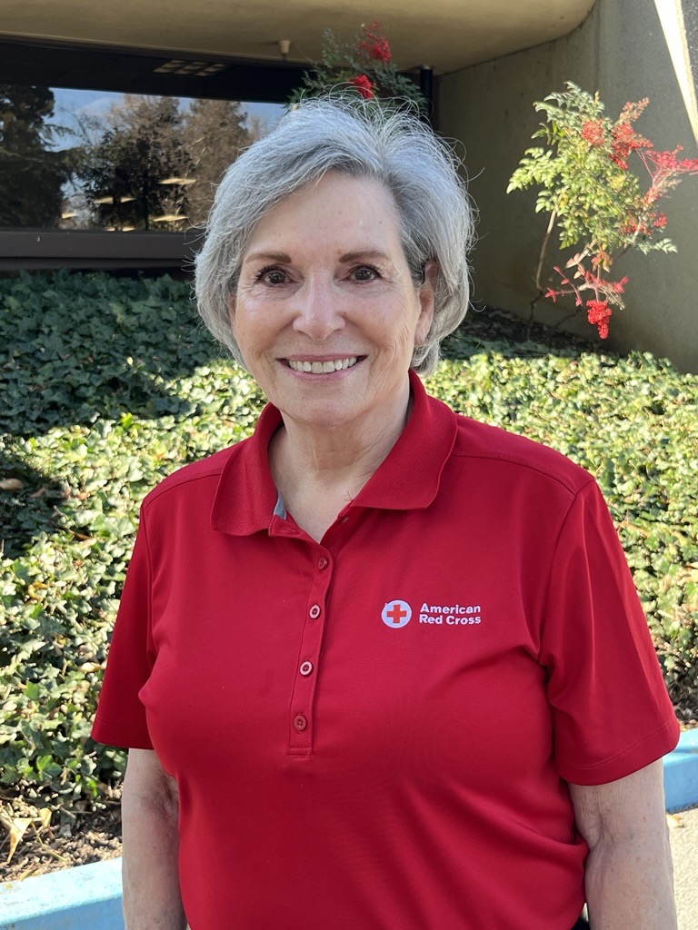 woman in red cross shirt