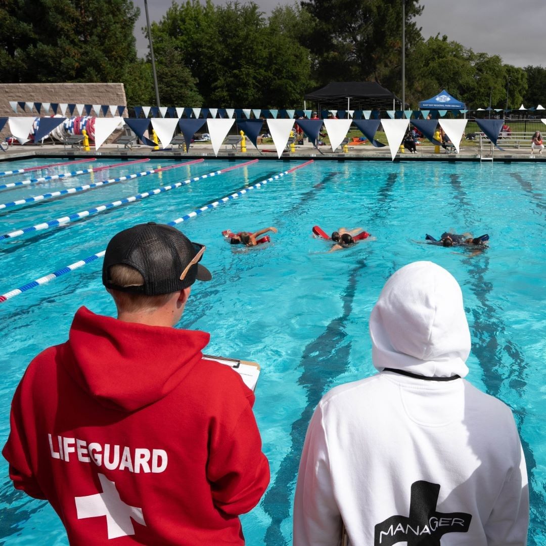 two lifeguards look out over pool