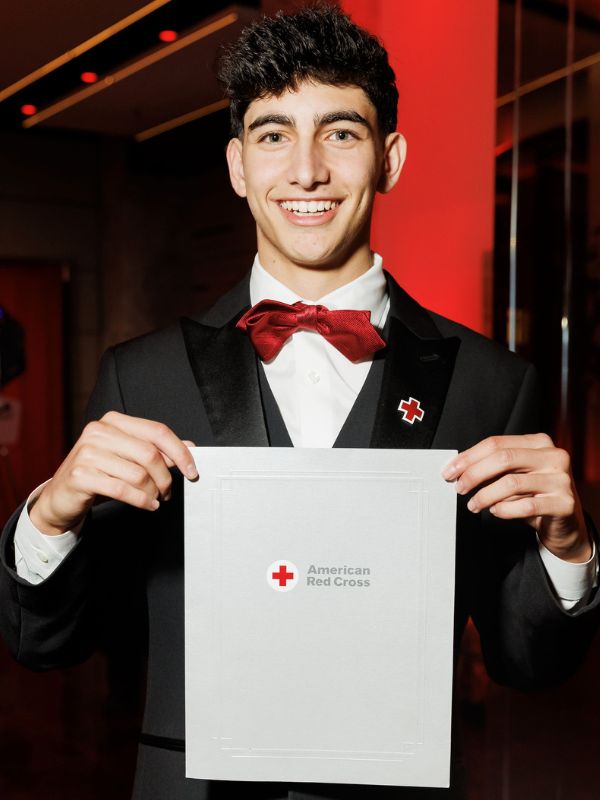 young man in green shirt with arms folded