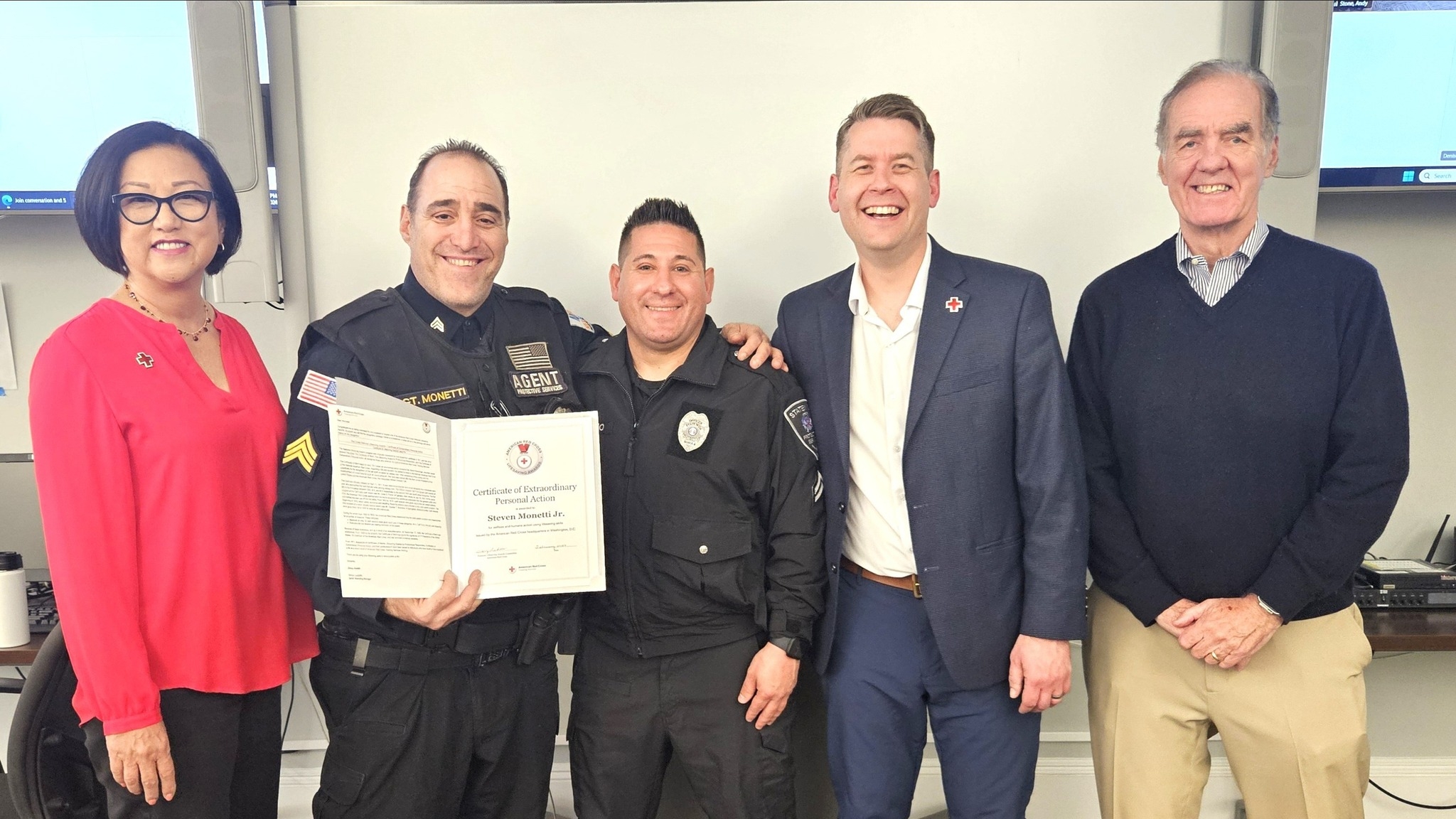 New Jersey security holding an award next to three people.
