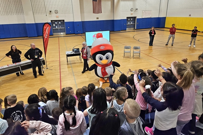 Prepare with Pedro Mascot talking to a group of children