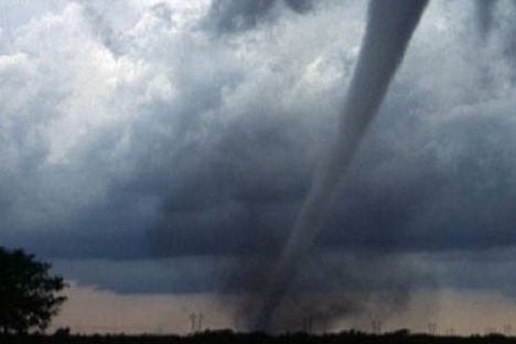 active tornado spinning with gray sky.