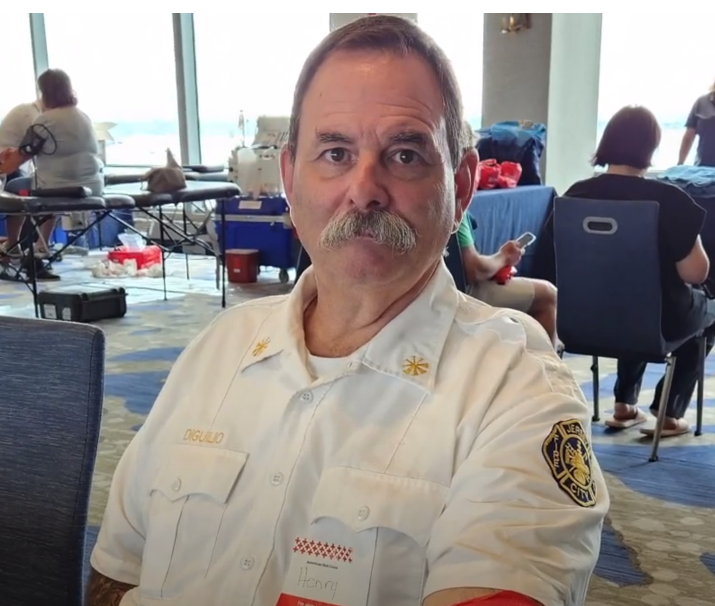 New jersey police man giving blood in uniform 