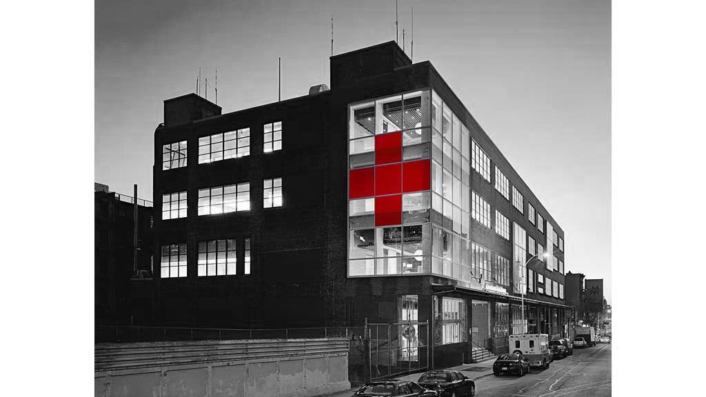 Building with five large windows painted red to make the Red Cross logo.