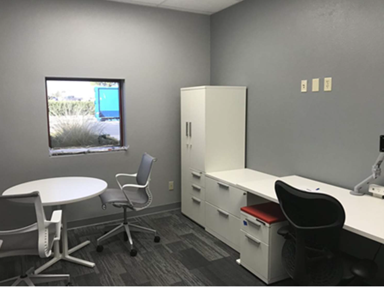 Huddle Room with chairs and desks.